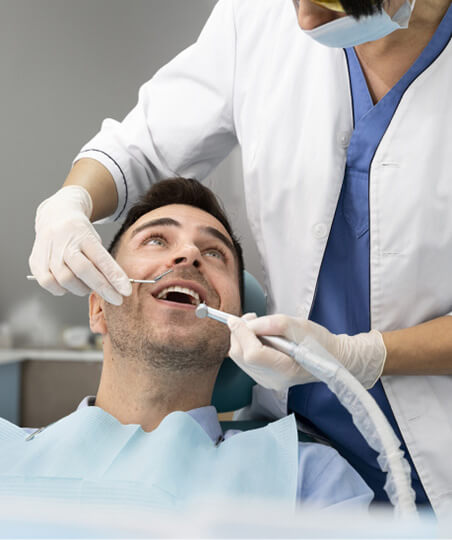 EU-trained dentist delivering a Hollywood Smile to a happy patient in Albania