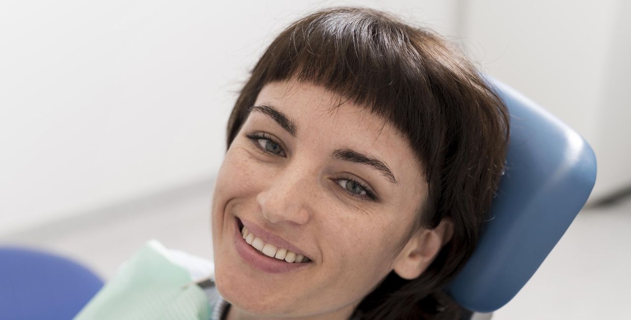 Patient smiling after receiving 24 Metal-Porcelan teeth in Albania